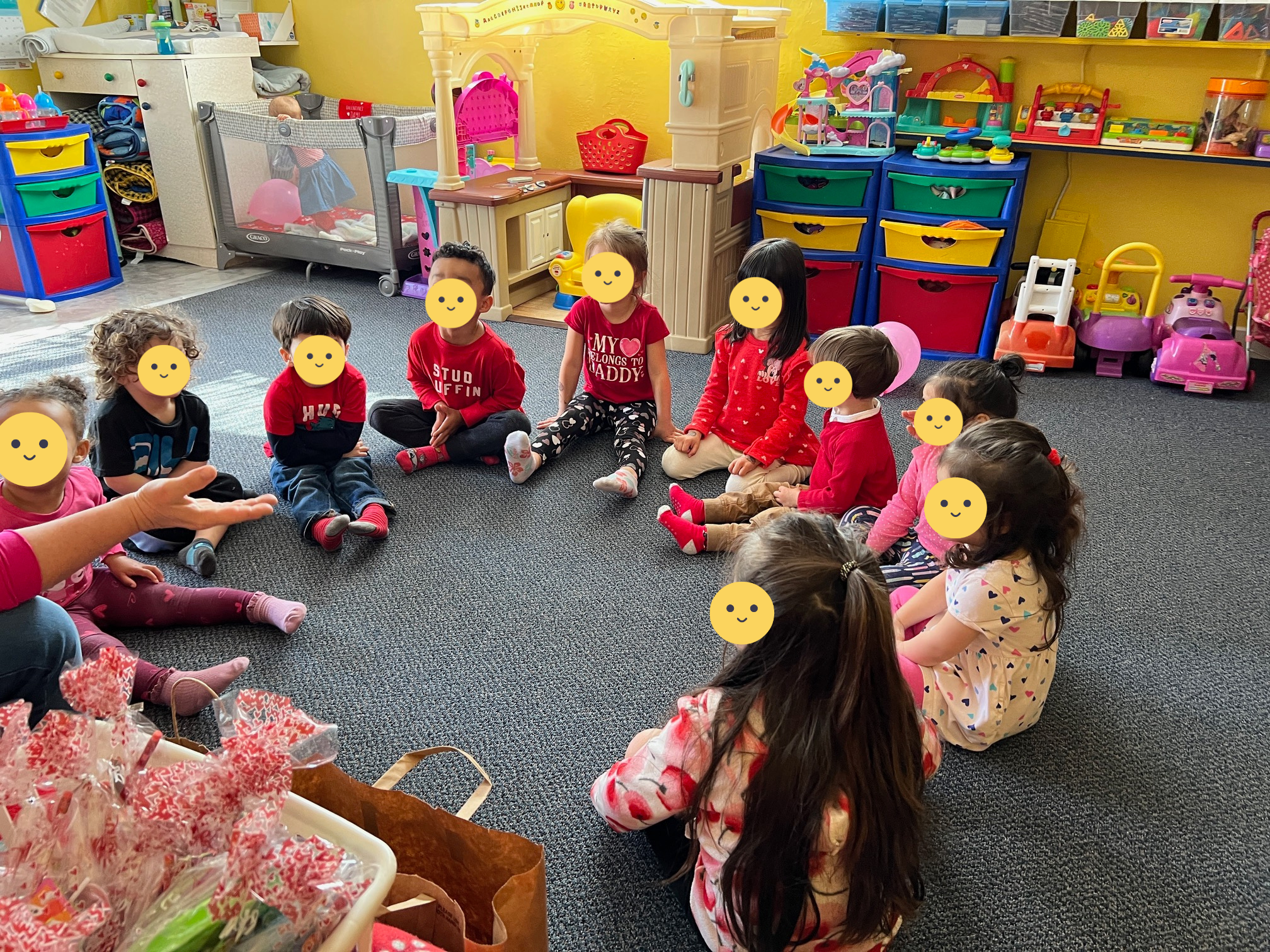 Children sitting in a circle while Lucy talks to them.